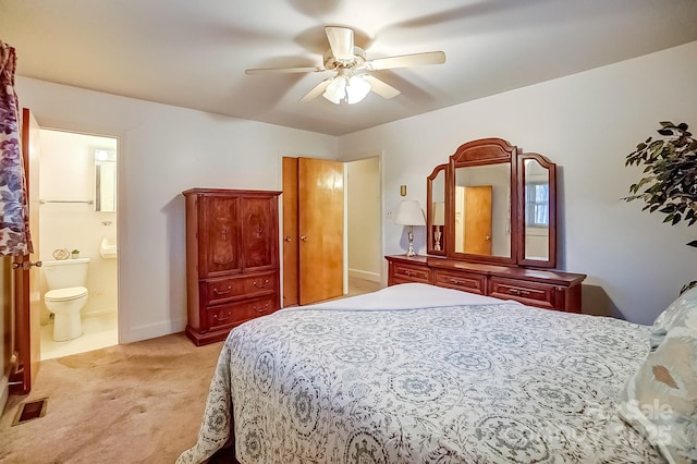 bedroom with visible vents, baseboards, ceiling fan, light colored carpet, and ensuite bathroom