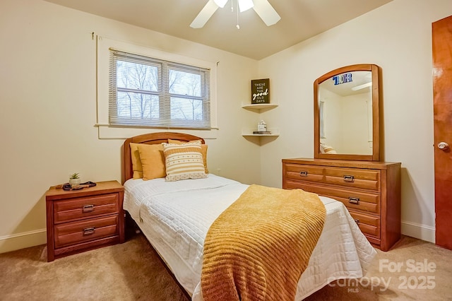 bedroom featuring light colored carpet, a ceiling fan, and baseboards