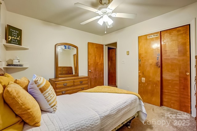 carpeted bedroom featuring a closet and a ceiling fan