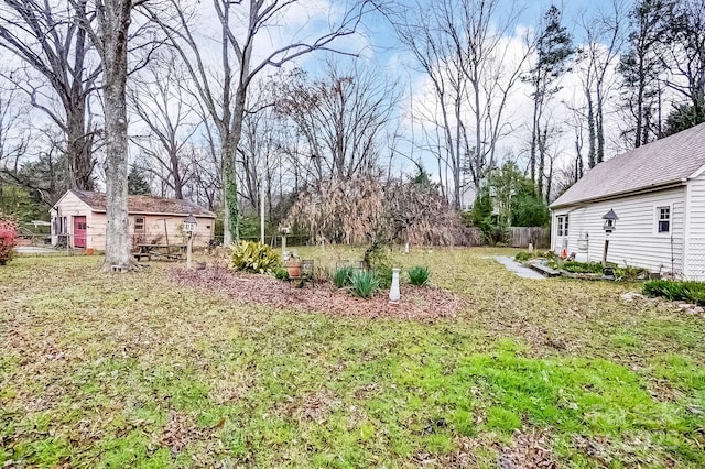 view of yard with an outdoor structure and fence