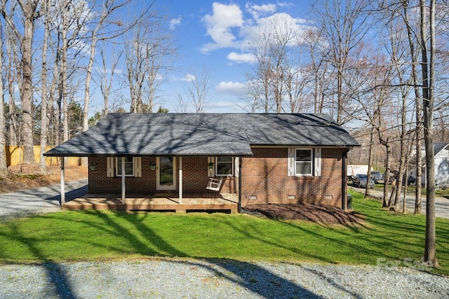 view of front facade with crawl space, driveway, brick siding, and a front lawn