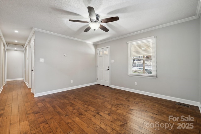 entryway with crown molding, dark wood-style floors, and visible vents