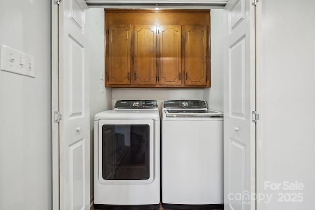 washroom with cabinet space and separate washer and dryer