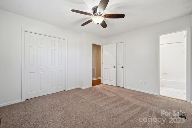 unfurnished bedroom with visible vents, a ceiling fan, ensuite bathroom, carpet floors, and baseboards