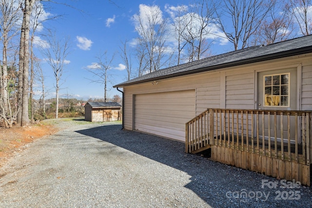 detached garage featuring a storage shed