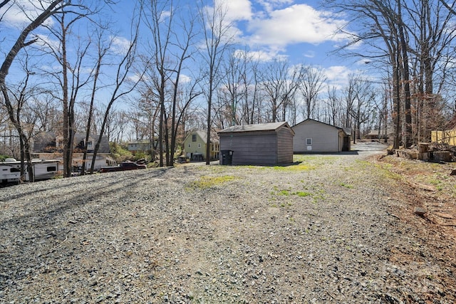 view of yard with an outbuilding and a shed