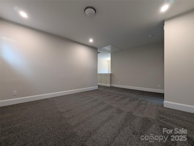 empty room with recessed lighting, attic access, baseboards, and dark colored carpet