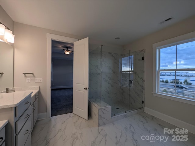 bathroom featuring a marble finish shower, visible vents, marble finish floor, and vanity