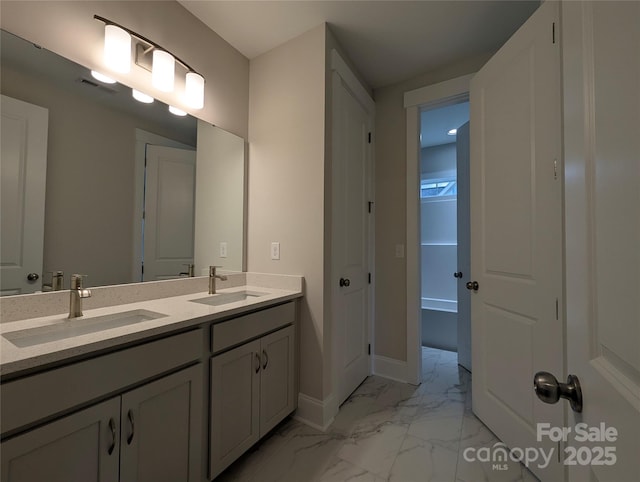 full bath with double vanity, visible vents, marble finish floor, and a sink