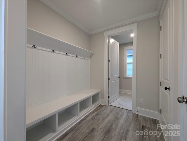 mudroom with wood finished floors, baseboards, and ornamental molding