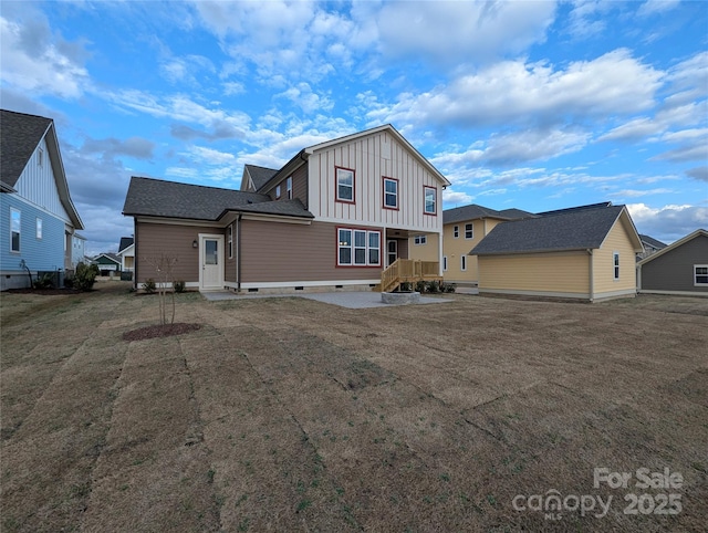 back of property featuring crawl space, a yard, and board and batten siding