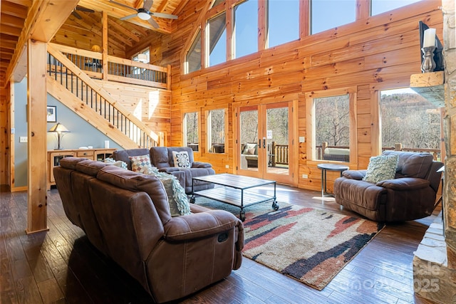 living room with wood walls, wooden ceiling, stairs, and hardwood / wood-style flooring