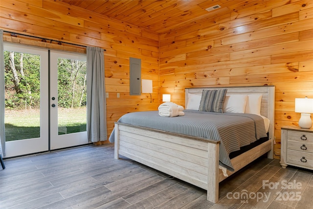 bedroom with access to exterior, wood walls, wooden ceiling, and wood finished floors