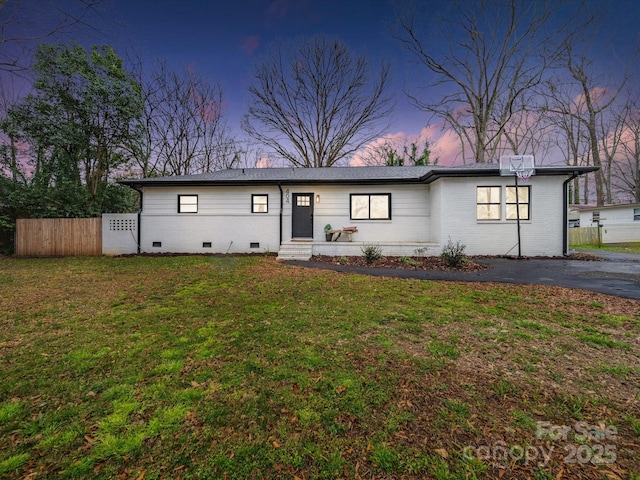 404 Plaza Dr, Harrisburg, NC 28075 - view of front of home with crawl space, a lawn, brick siding, and fence