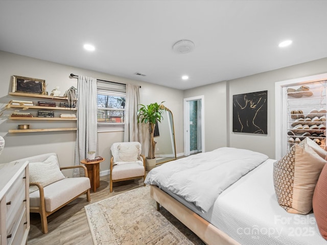 bedroom featuring recessed lighting, visible vents, and wood finished floors