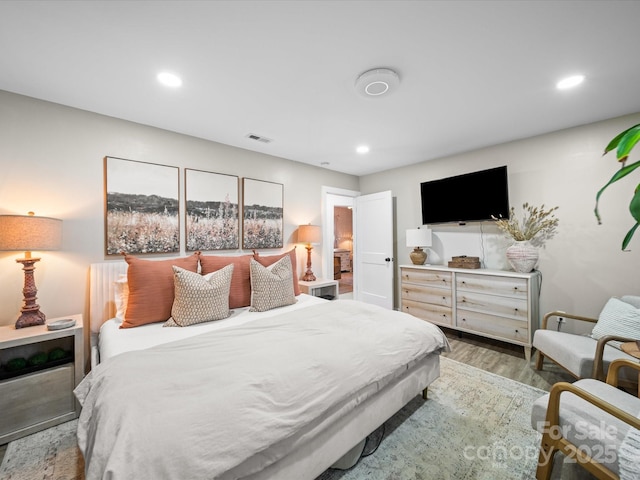 bedroom with visible vents, recessed lighting, and wood finished floors