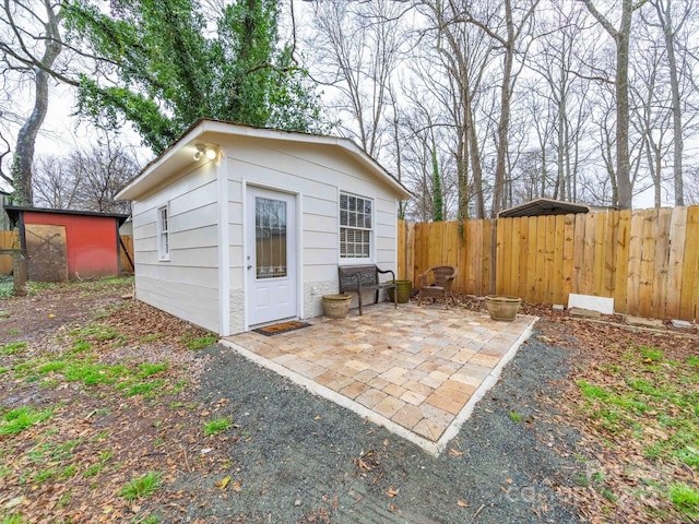 view of outdoor structure featuring an outbuilding and fence