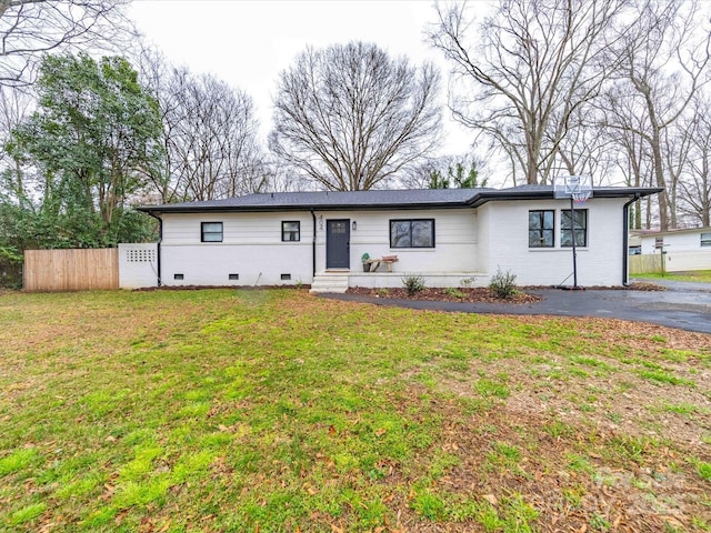 single story home with brick siding, fence, a front yard, crawl space, and driveway