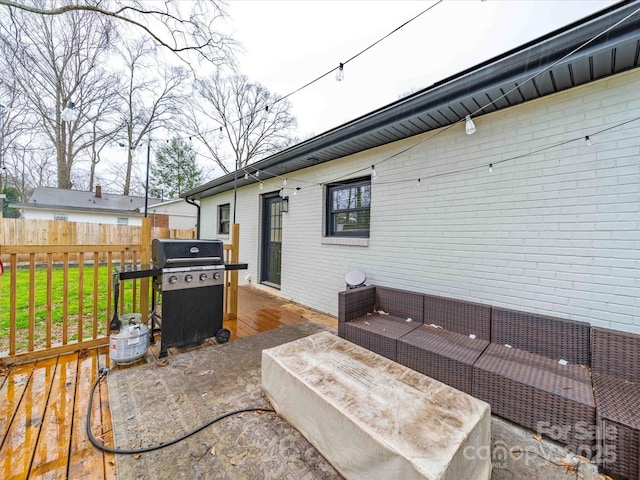 view of patio featuring an outdoor hangout area, area for grilling, a deck, and fence