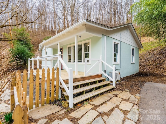 view of front of house featuring covered porch and stucco siding