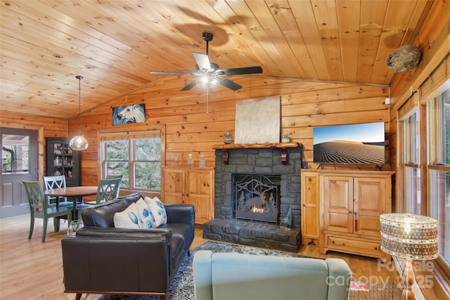 living room with a ceiling fan, lofted ceiling, light wood-style flooring, and wood ceiling