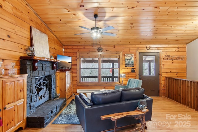 living room with wooden walls, ceiling fan, vaulted ceiling, wooden ceiling, and wood finished floors