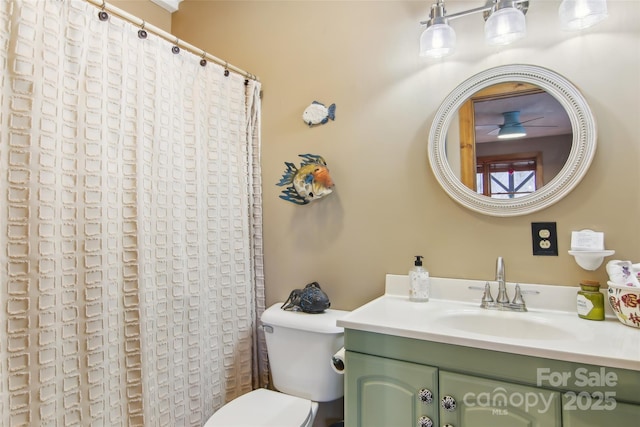 bathroom featuring a ceiling fan, toilet, vanity, and a shower with curtain