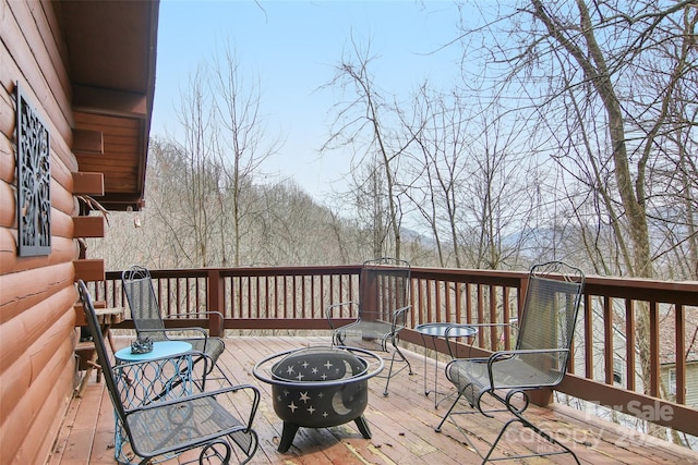 wooden terrace featuring a fire pit