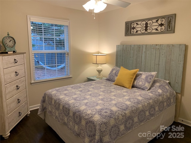 bedroom featuring ceiling fan, baseboards, and dark wood finished floors