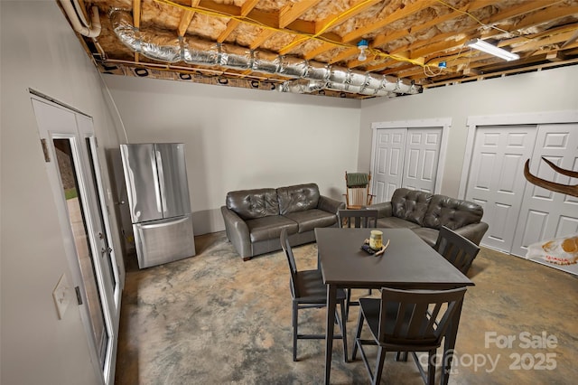 dining area with unfinished concrete flooring