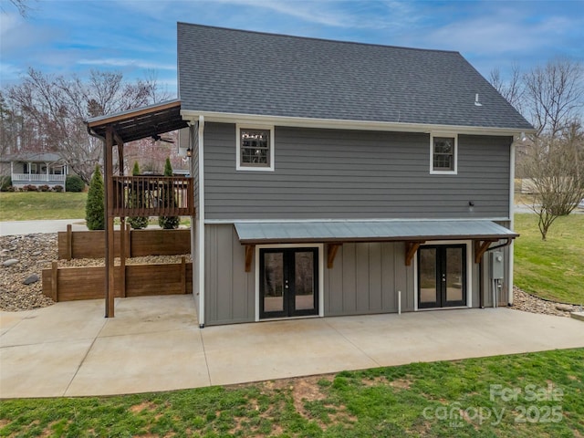 back of property with a patio area, french doors, and a shingled roof