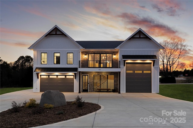 view of front of home with a standing seam roof, board and batten siding, concrete driveway, and a balcony