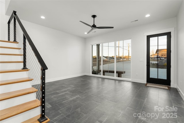 empty room with baseboards, visible vents, recessed lighting, ceiling fan, and stairs