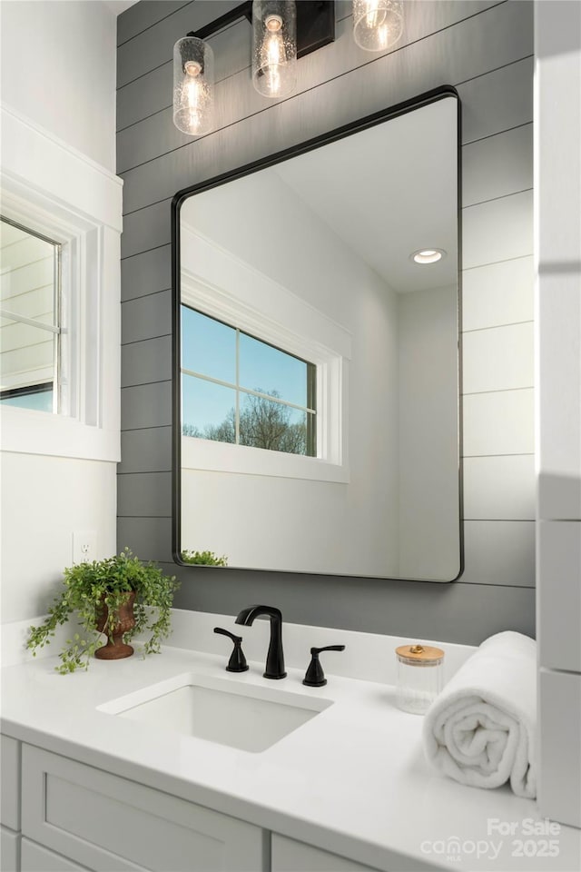 bathroom with wooden walls and vanity