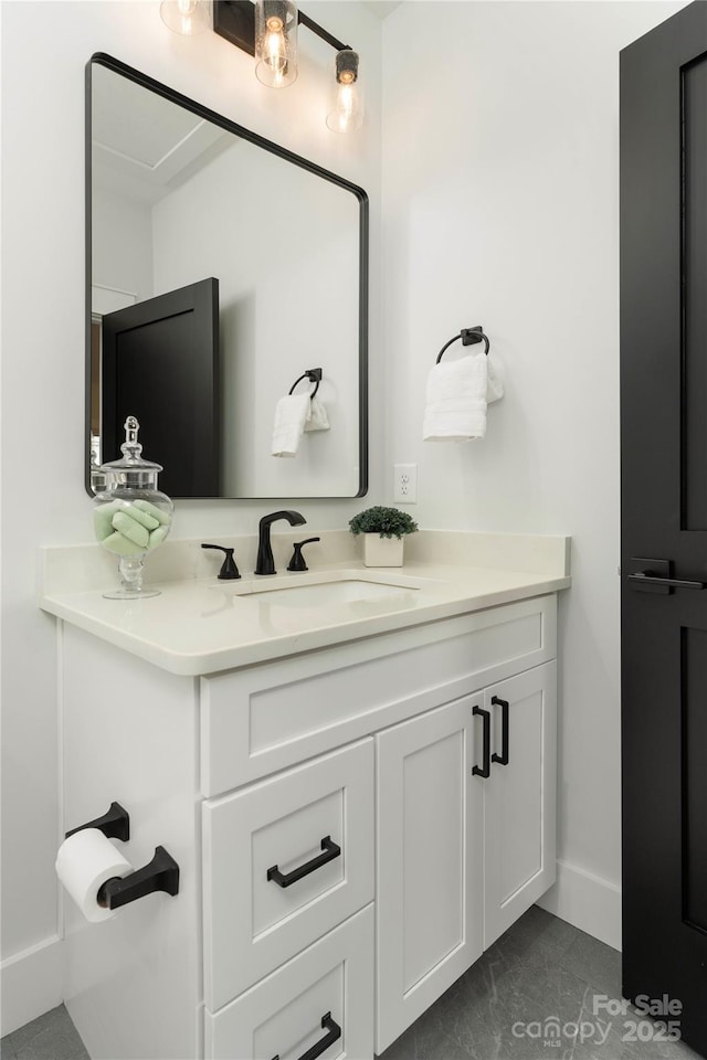 bathroom featuring baseboards and vanity