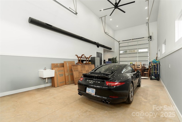 garage with recessed lighting, baseboards, and a sink