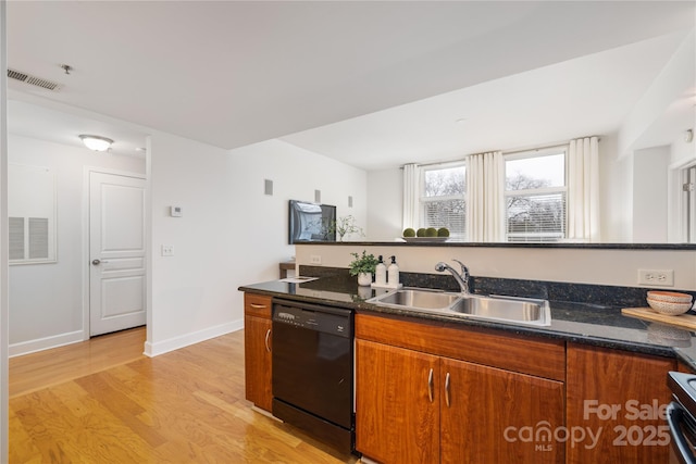 kitchen with a sink, dishwasher, light wood-style flooring, and brown cabinetry