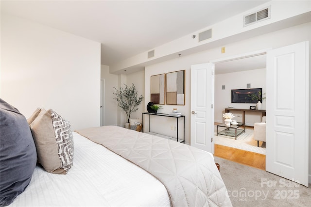 carpeted bedroom with visible vents