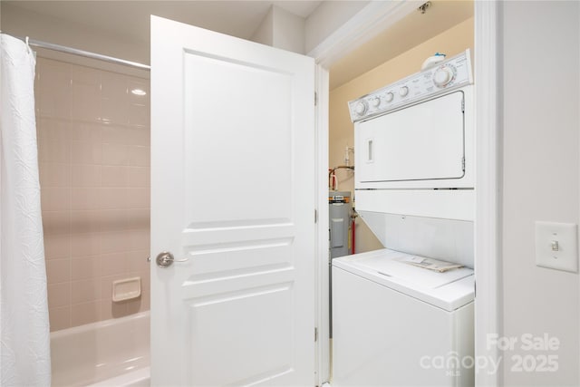 laundry area with laundry area and stacked washer / drying machine