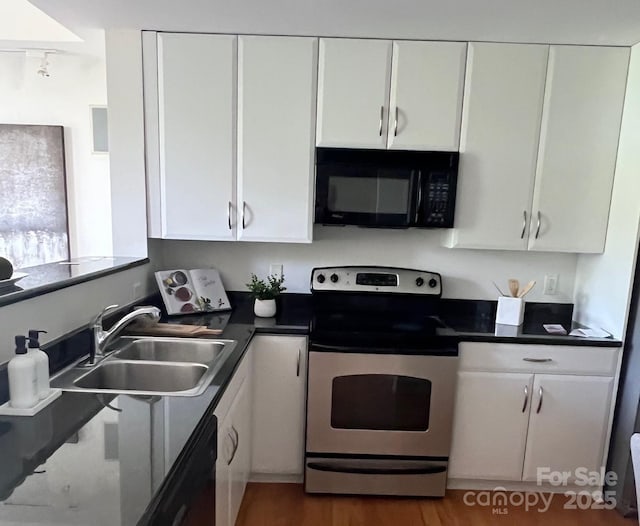 1320 Fillmore St Unit 419, Charlotte, NC 28203 - kitchen featuring black appliances, white cabinets, and dark countertops