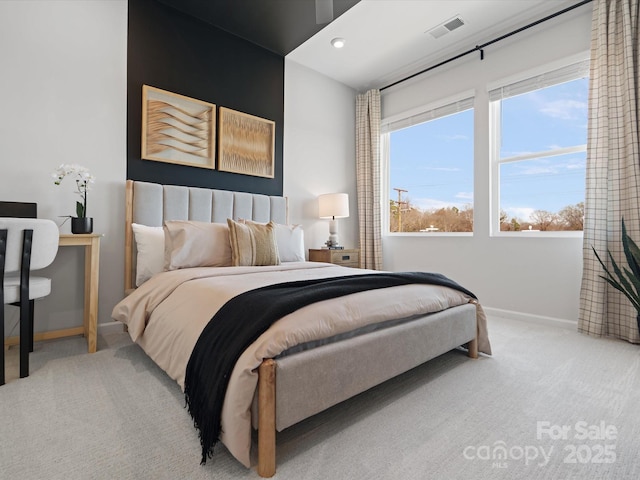 carpeted bedroom with visible vents and baseboards