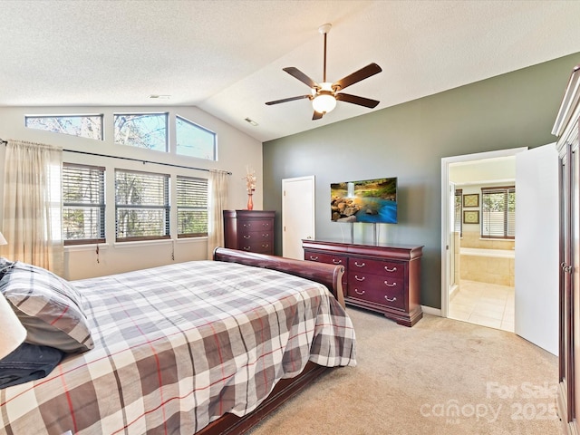 bedroom featuring light carpet, a textured ceiling, connected bathroom, lofted ceiling, and ceiling fan