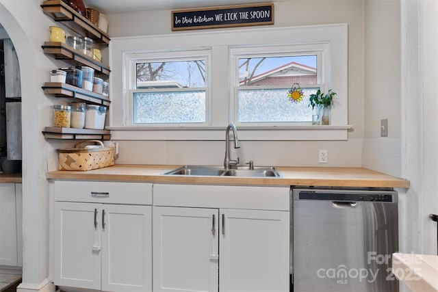 kitchen with open shelves, dishwasher, wood counters, and a sink