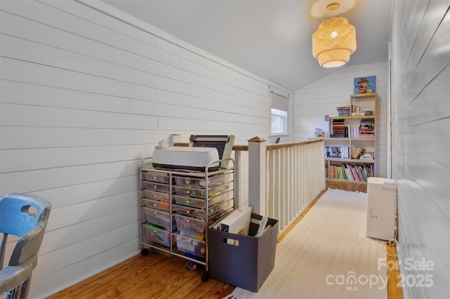 interior space with wood finished floors and vaulted ceiling