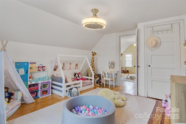 recreation room with lofted ceiling and wood finished floors