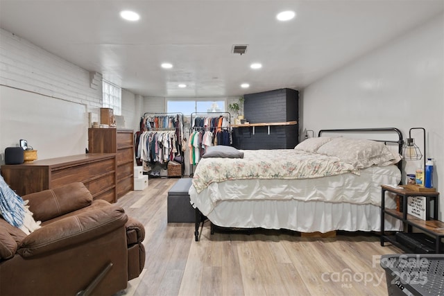 bedroom with recessed lighting, visible vents, and wood finished floors