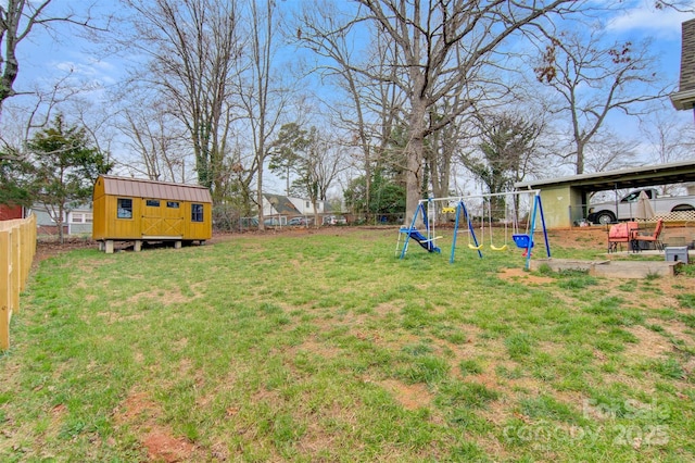 view of yard with a fenced backyard, a storage unit, a playground, and an outdoor structure