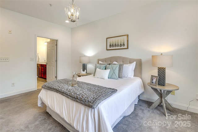 carpeted bedroom featuring ensuite bath, baseboards, and an inviting chandelier