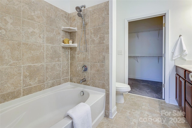 full bath featuring a spacious closet, tub / shower combination, toilet, and baseboards