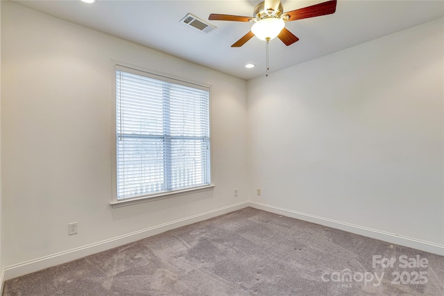 empty room with visible vents, recessed lighting, carpet floors, baseboards, and ceiling fan